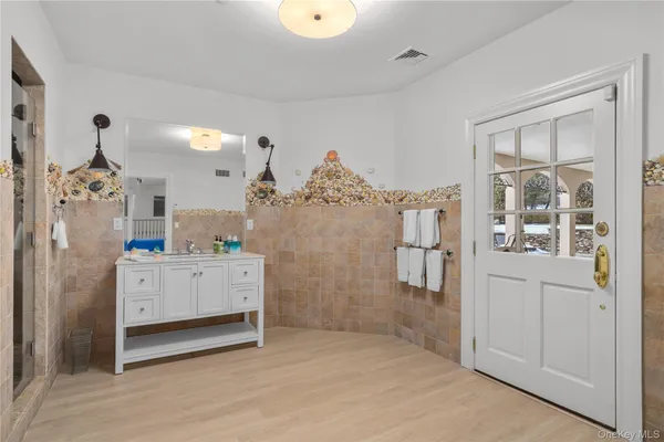 a bathroom with a granite countertop sink toilet and shower
