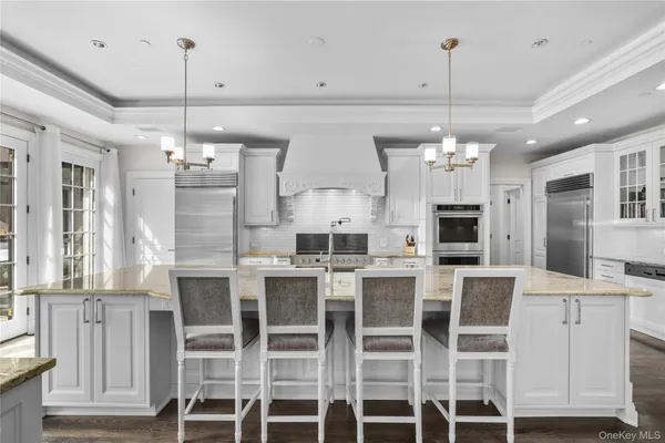 a large kitchen with a table and chairs