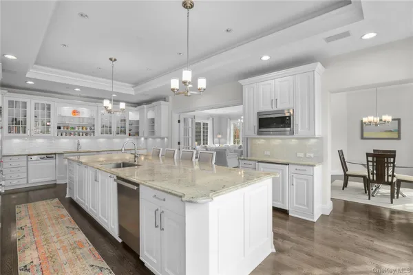 a kitchen with stainless steel appliances granite countertop a sink a stove top oven a counter space and cabinets
