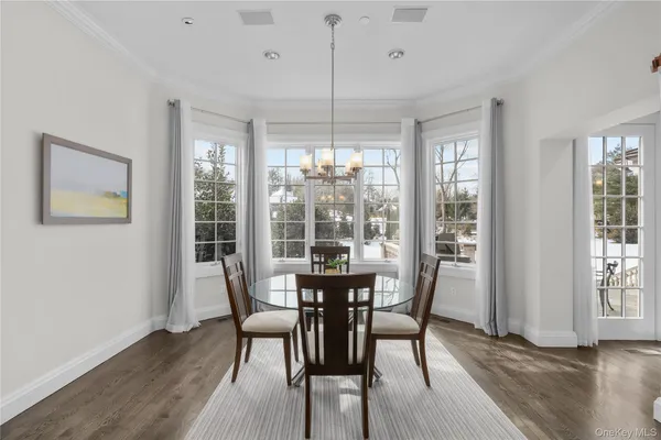 a view of a dining room with furniture window and wooden floor