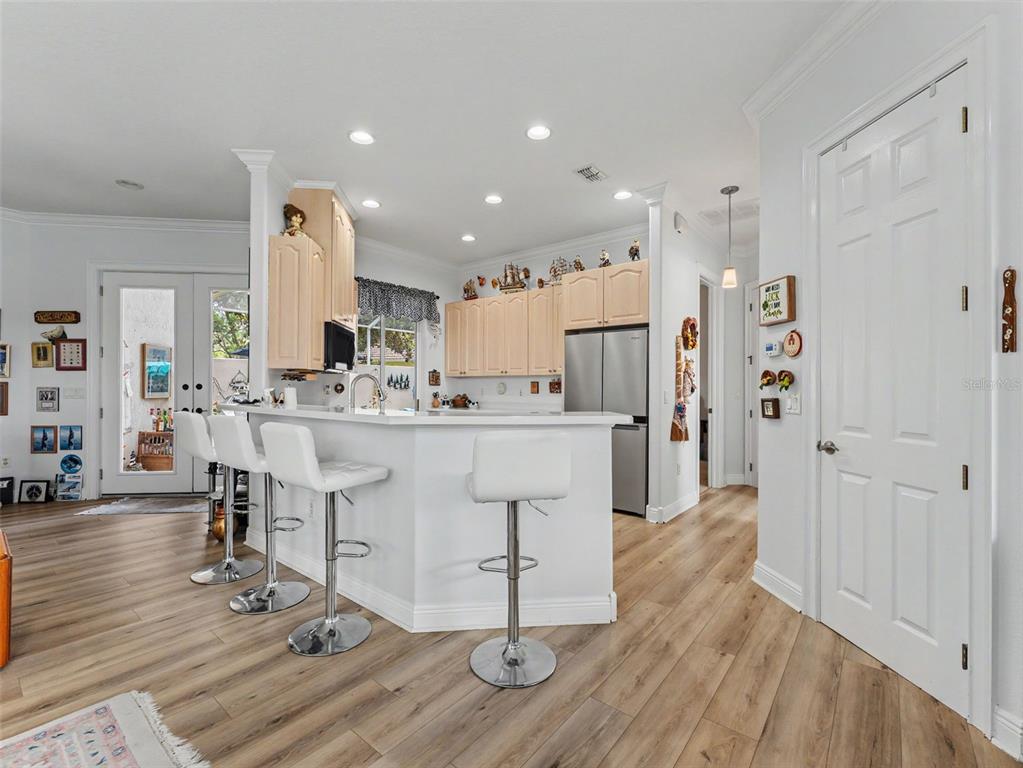 8910 Jericho Road Weeki Wachee, FL 34613 - Photo 23 of 52 a living room with stainless steel appliances kitchen island granite countertop a dining table chairs and view living room