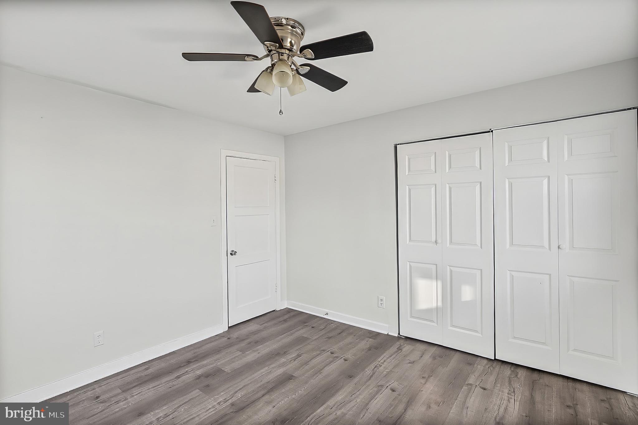 30 North Athol Avenue Baltimore, MD 21229 - Photo 11 of 20 an empty room with wooden floor and windows