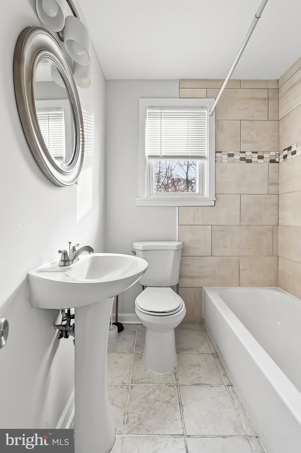 30 North Athol Avenue Baltimore, MD 21229 - Photo 12 of 20 a bathroom with a sink a toilet and a mirror