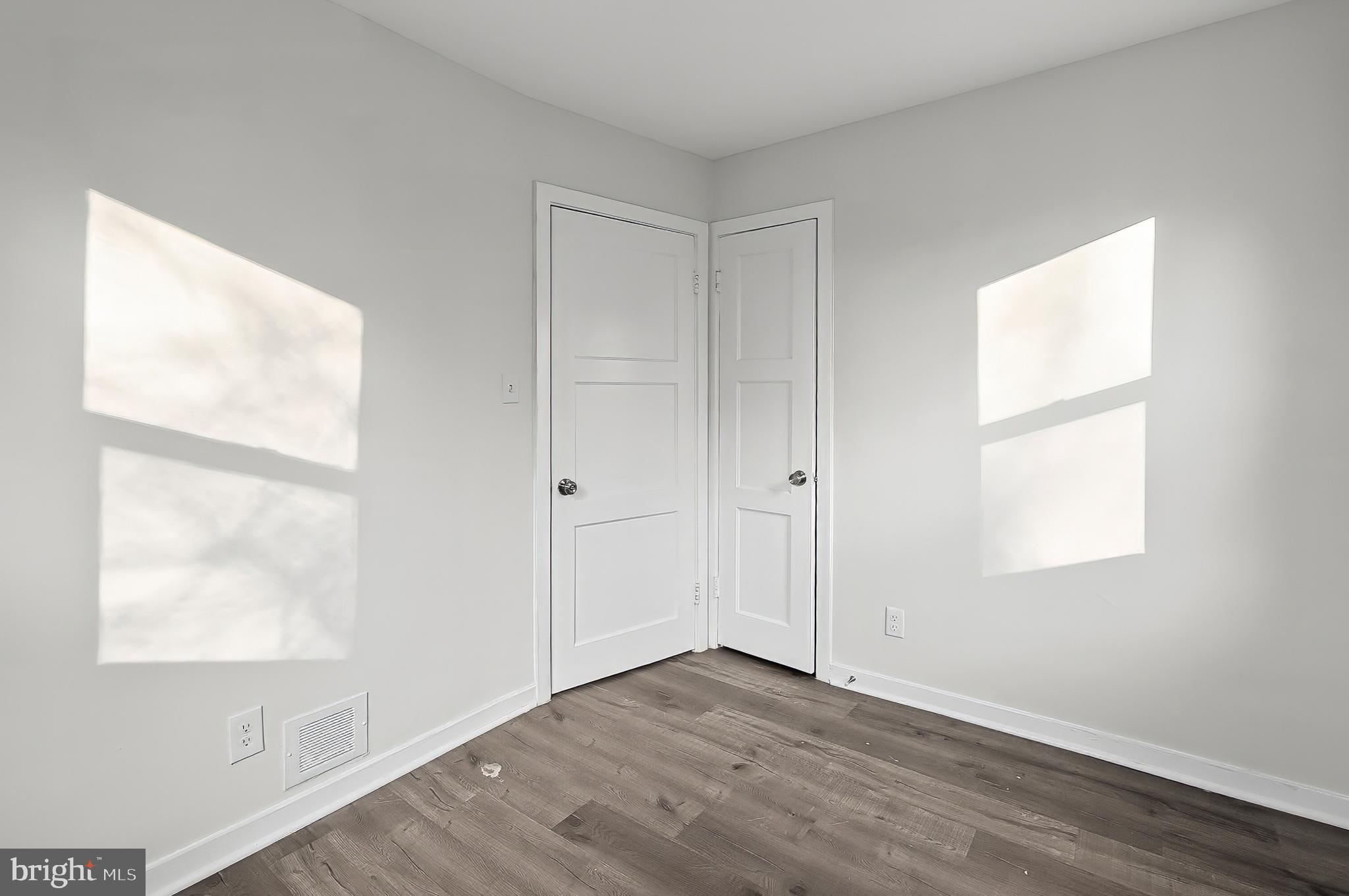 30 North Athol Avenue Baltimore, MD 21229 - Photo 16 of 20 an empty room with wooden floor and windows