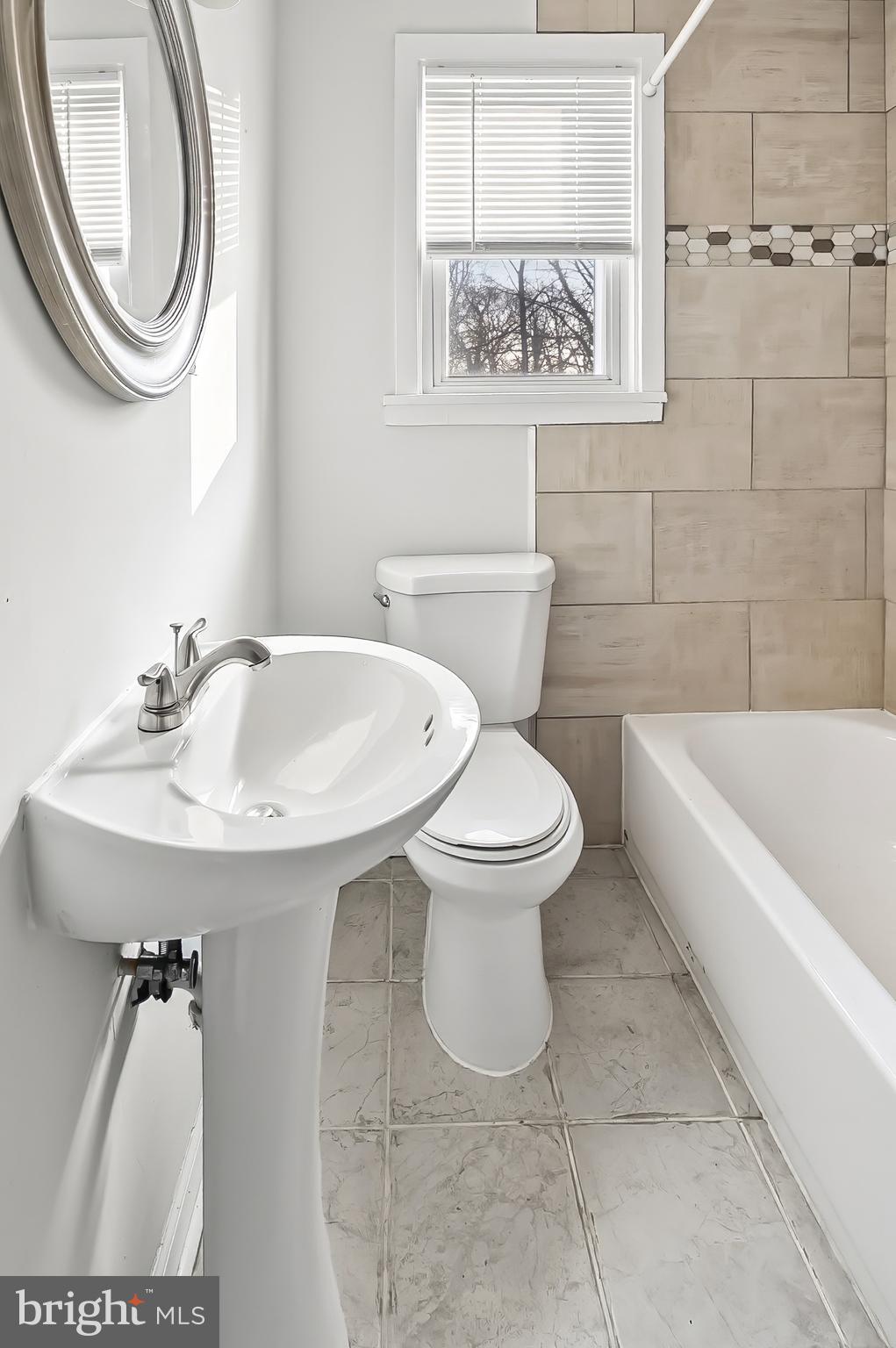 30 North Athol Avenue Baltimore, MD 21229 - Photo 17 of 20 a bathroom with a sink and a mirror