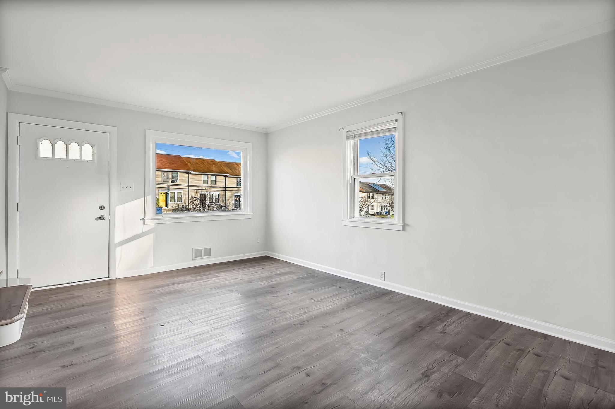 30 North Athol Avenue Baltimore, MD 21229 - Photo 4 of 20 an empty room with wooden floor and a window