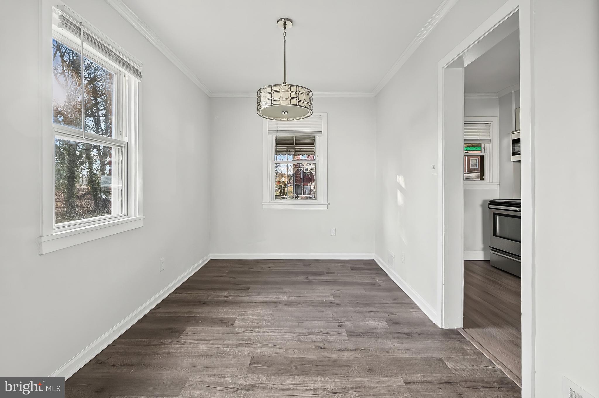 30 North Athol Avenue Baltimore, MD 21229 - Photo 5 of 20 a view of an hallway with wooden floor and a window