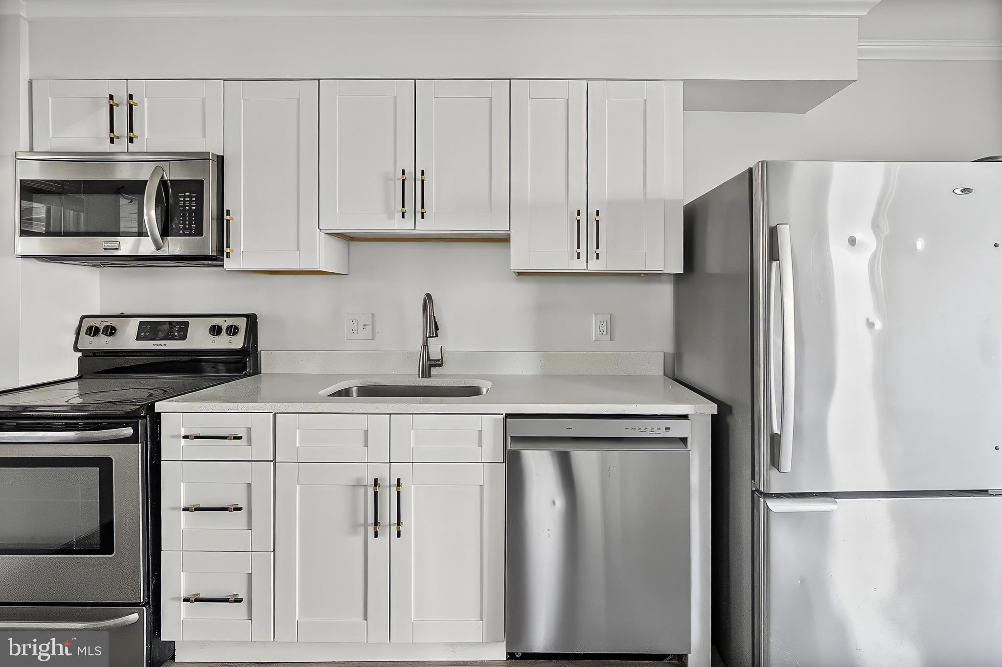 30 North Athol Avenue Baltimore, MD 21229 - Photo 7 of 20 a kitchen with cabinets stainless steel appliances and a counter space