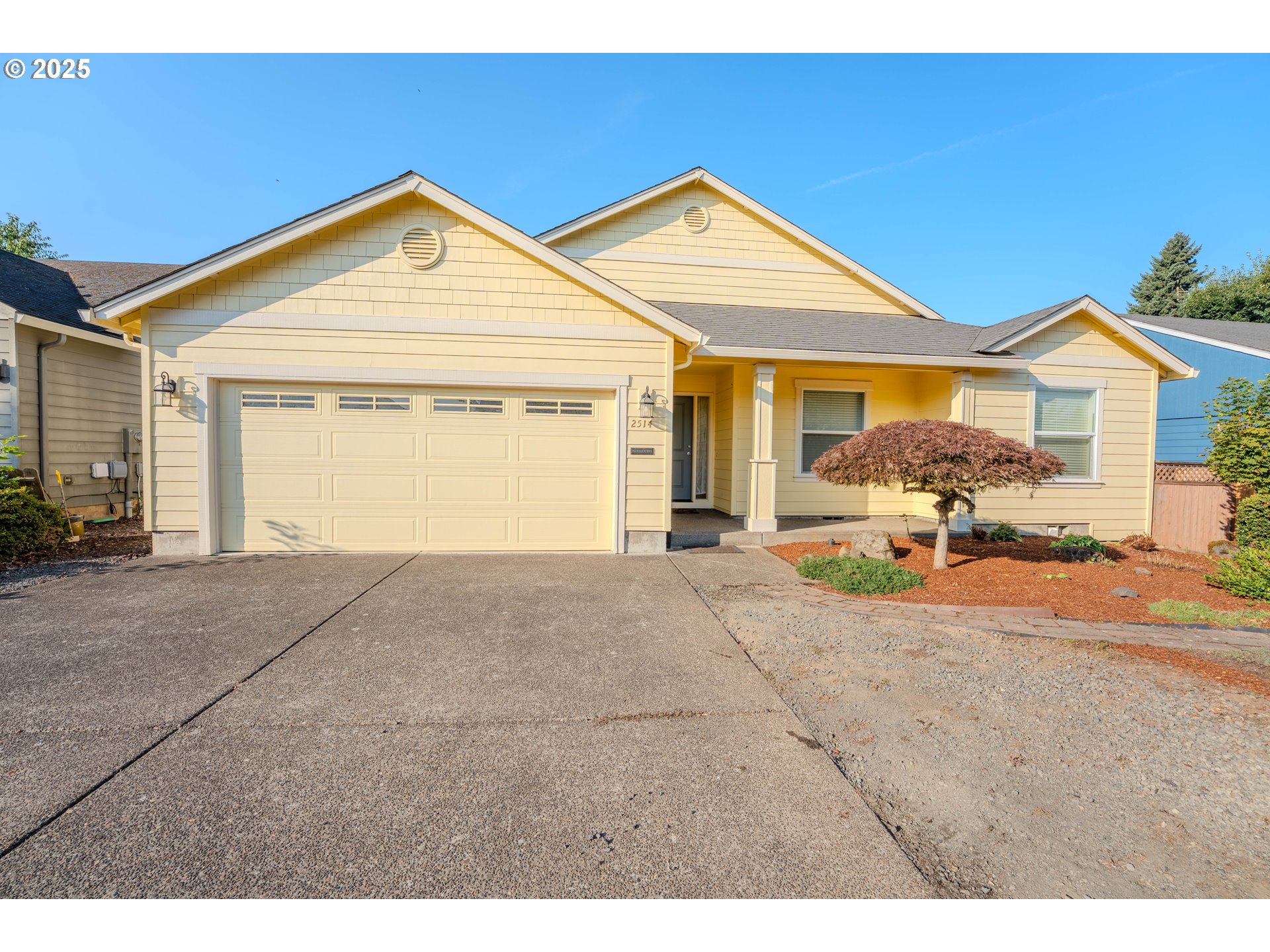 a view of a house with a yard and garage