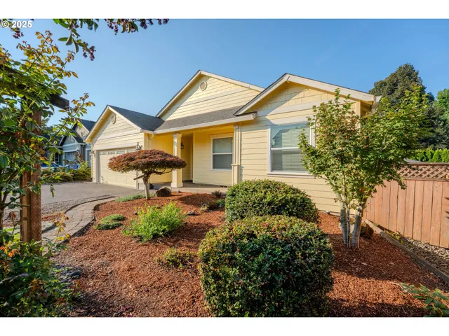 a backyard of a house with table and chairs