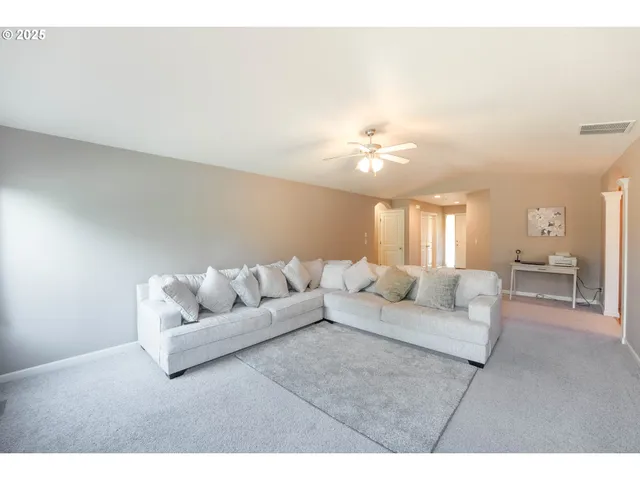 a living room with furniture and a lamp