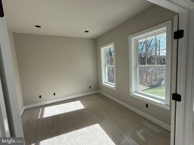 an empty room with windows and closet in a room