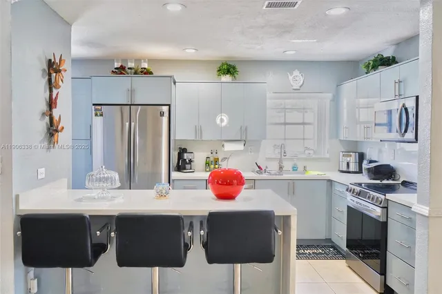 a kitchen with stainless steel appliances a sink and cabinets