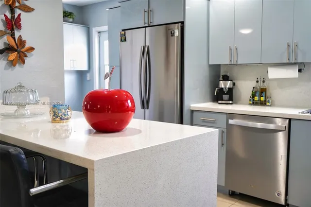 a kitchen with stainless steel appliances a refrigerator sink and cabinets