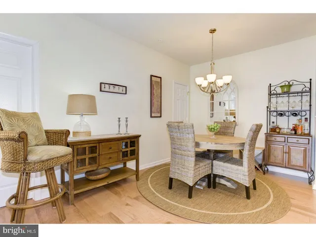 a living room with furniture a chandelier and a table