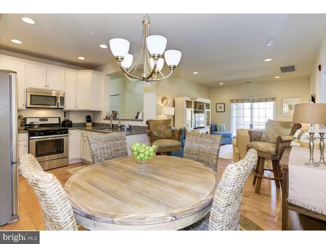 a kitchen with a dining table and chairs