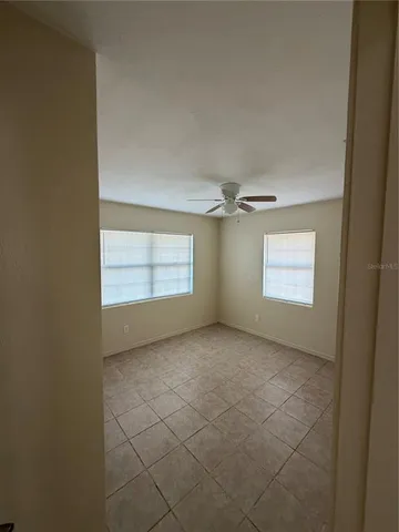 an empty room with windows and closet