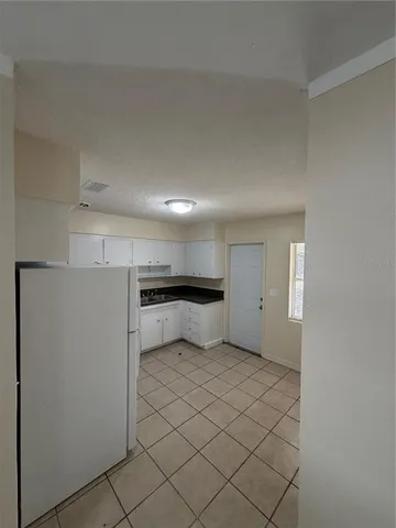 a view of a kitchen with a refrigerator