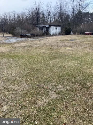 a view of yard covered with snow in front of house