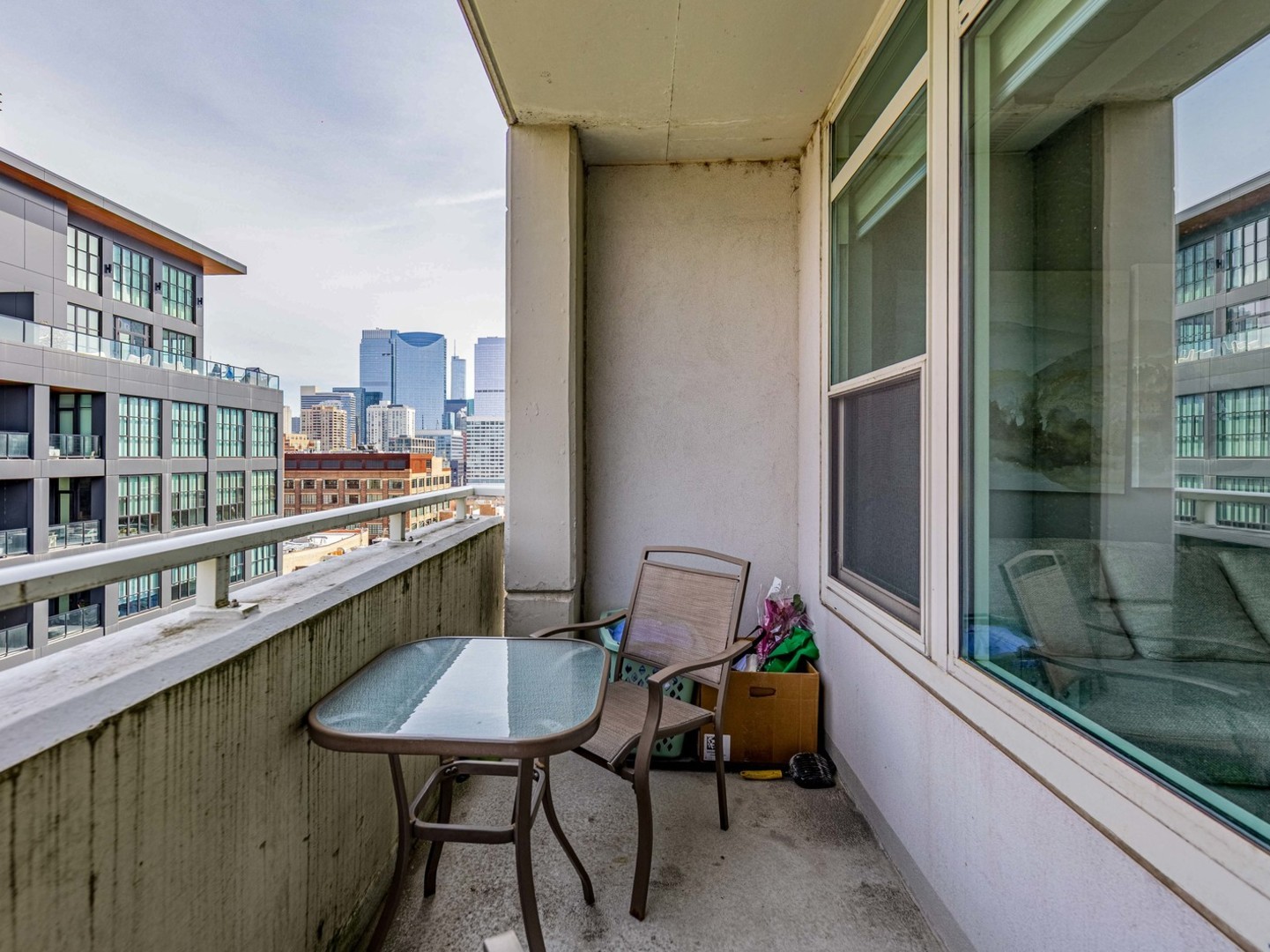 909 West Washington Boulevard, Unit 911 Chicago, IL 60607 - Photo 17 of 26 a balcony with a table and chairs