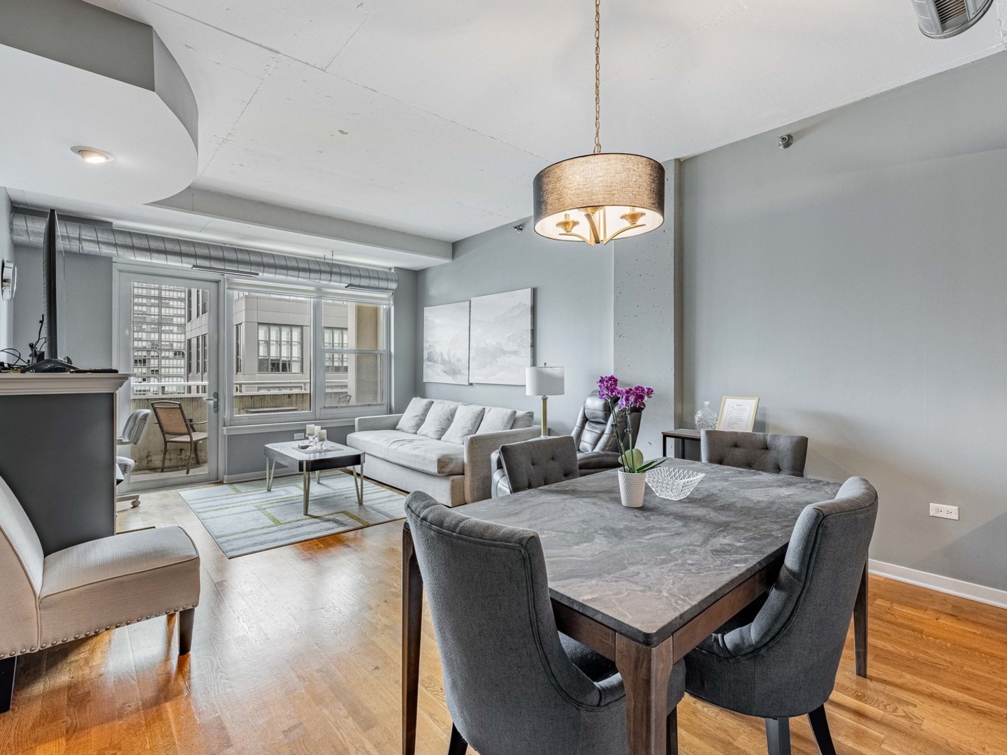 909 West Washington Boulevard, Unit 911 Chicago, IL 60607 - Photo 5 of 26 a view of a dining room with furniture wooden floor and chandelier