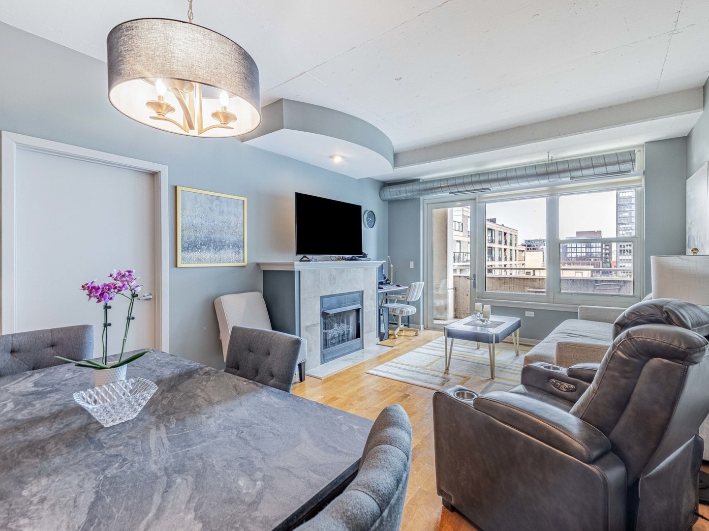 909 West Washington Boulevard, Unit 911 Chicago, IL 60607 - Photo 6 of 26 a living room with furniture a flat screen tv and a large window