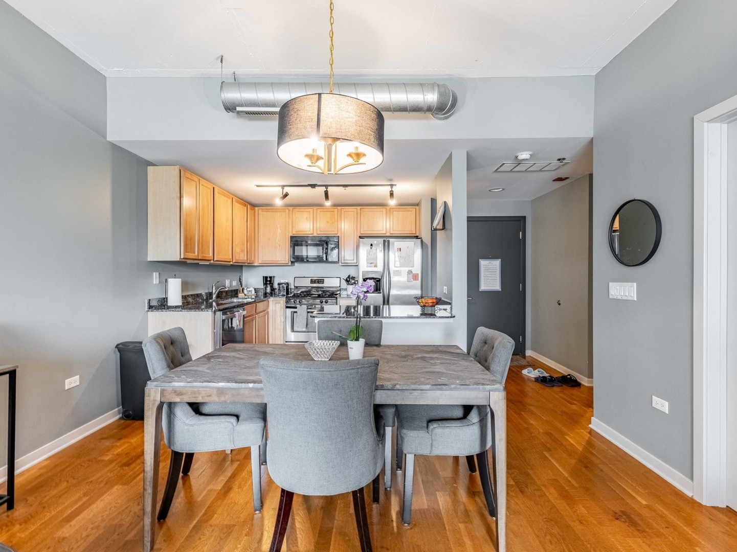 909 West Washington Boulevard, Unit 911 Chicago, IL 60607 - Photo 7 of 26 a view of a dining room with furniture window and wooden floor
