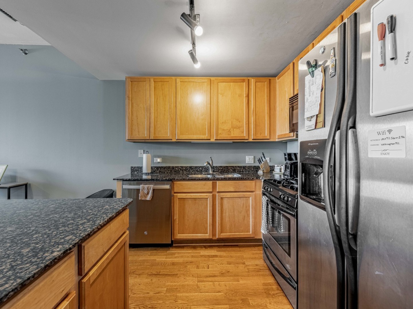 909 West Washington Boulevard, Unit 911 Chicago, IL 60607 - Photo 9 of 26 a kitchen with stainless steel appliances granite countertop a sink a stove and a refrigerator