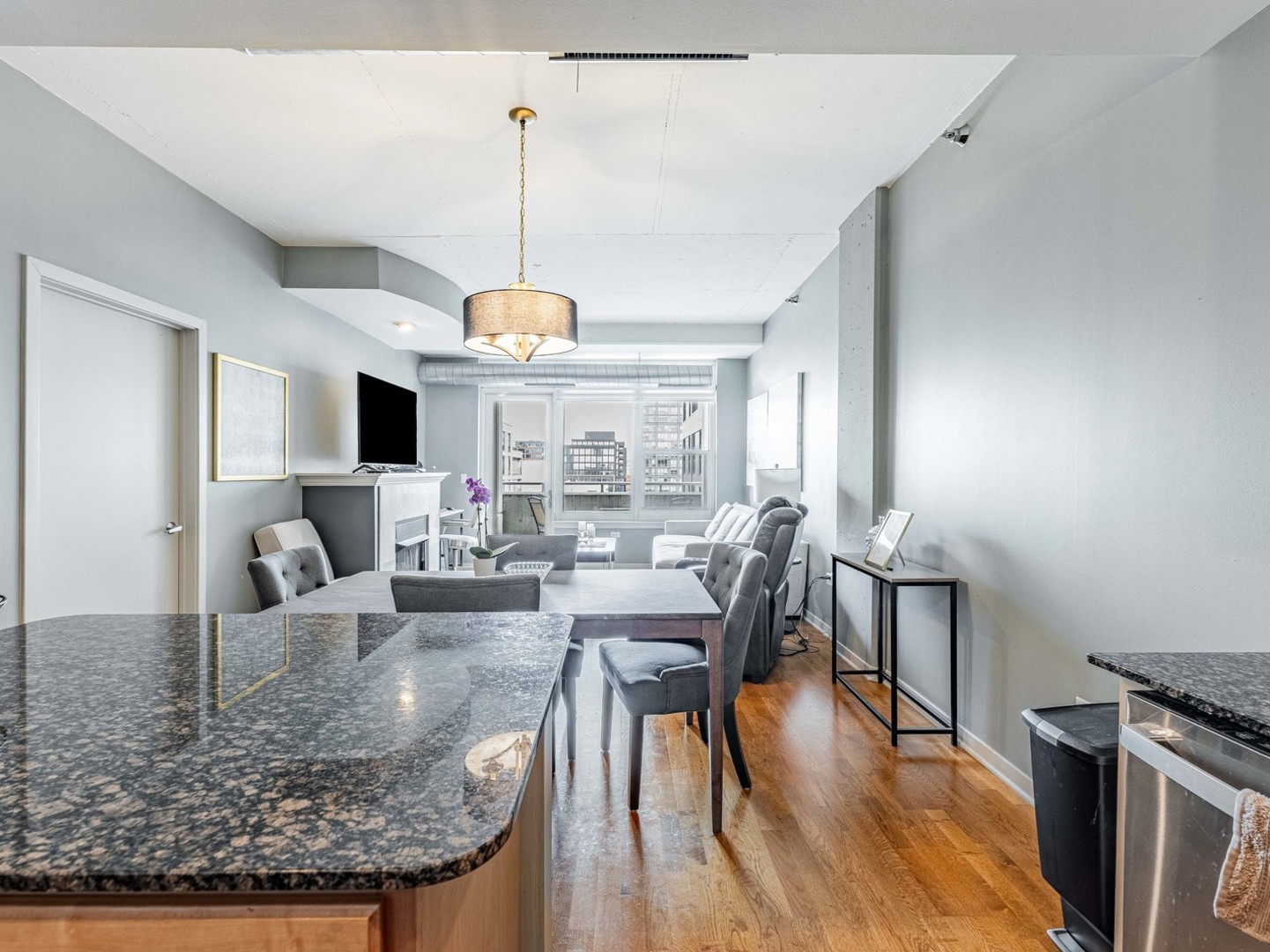 909 West Washington Boulevard, Unit 911 Chicago, IL 60607 - Photo 10 of 26 a view of a dining room with furniture window and wooden floor