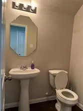 a white toilet sitting next to a bathroom sink