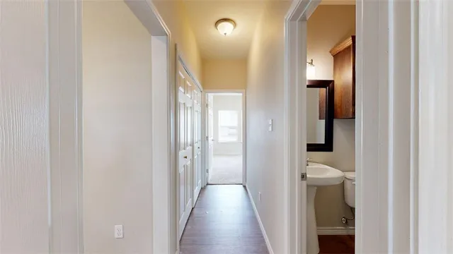 a kitchen with stainless steel appliances granite countertop a refrigerator a stove top oven a sink dishwasher and wooden floor