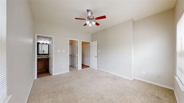 a view of a livingroom with a ceiling fan and window