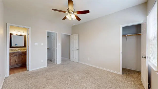 a bathroom with a granite countertop toilet sink and mirror