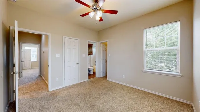 a bathroom with a granite countertop toilet sink and mirror
