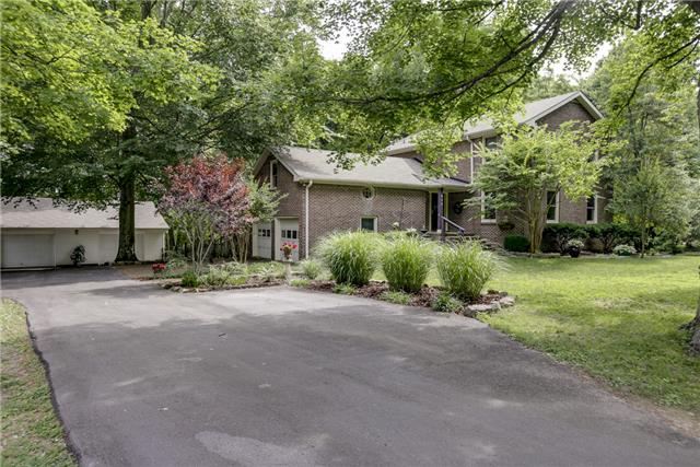 a front view of a house with a yard and a garage