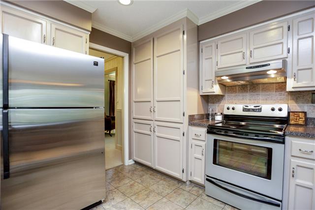 215 Lawrence Lane Springfield, TN 37172 - Photo 6 of 20 a kitchen with white cabinets and stainless steel appliances