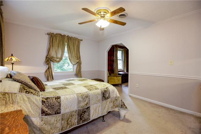 215 Lawrence Lane Springfield, TN 37172 - Photo 10 of 20 a bedroom with a bed and a chandelier
