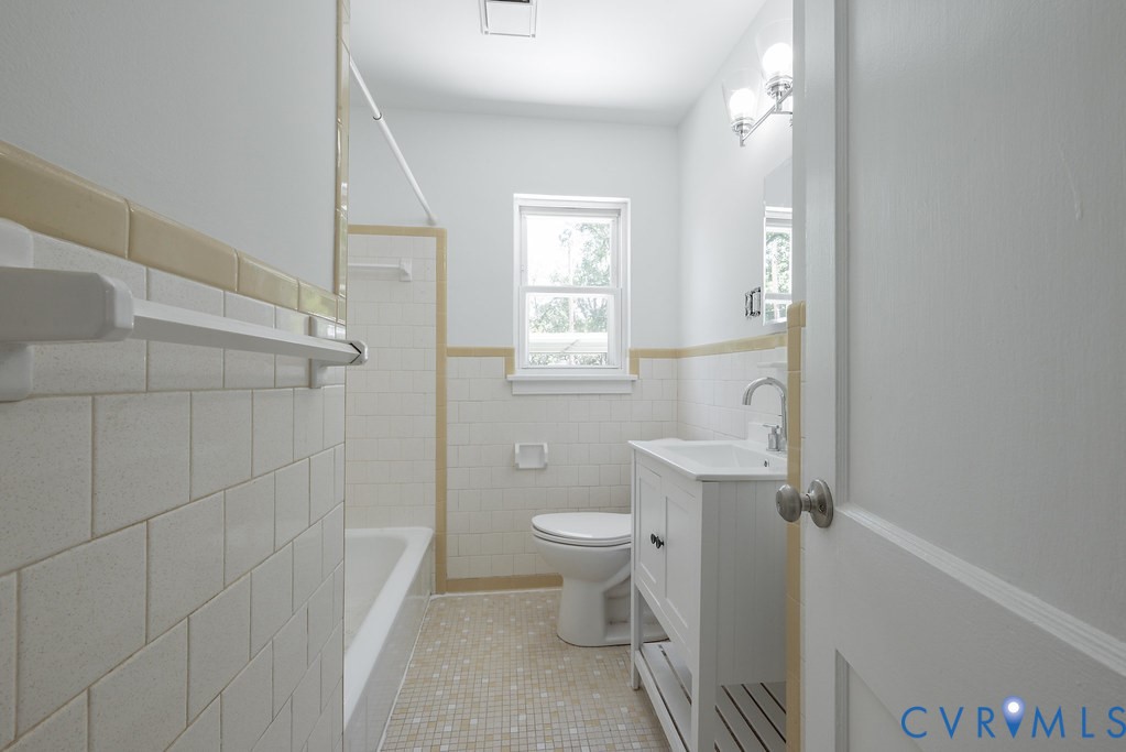 3400 Ryburn Road Richmond, VA 23234 - Photo 25 of 45 Bathroom featuring white wall tiling, a window, an