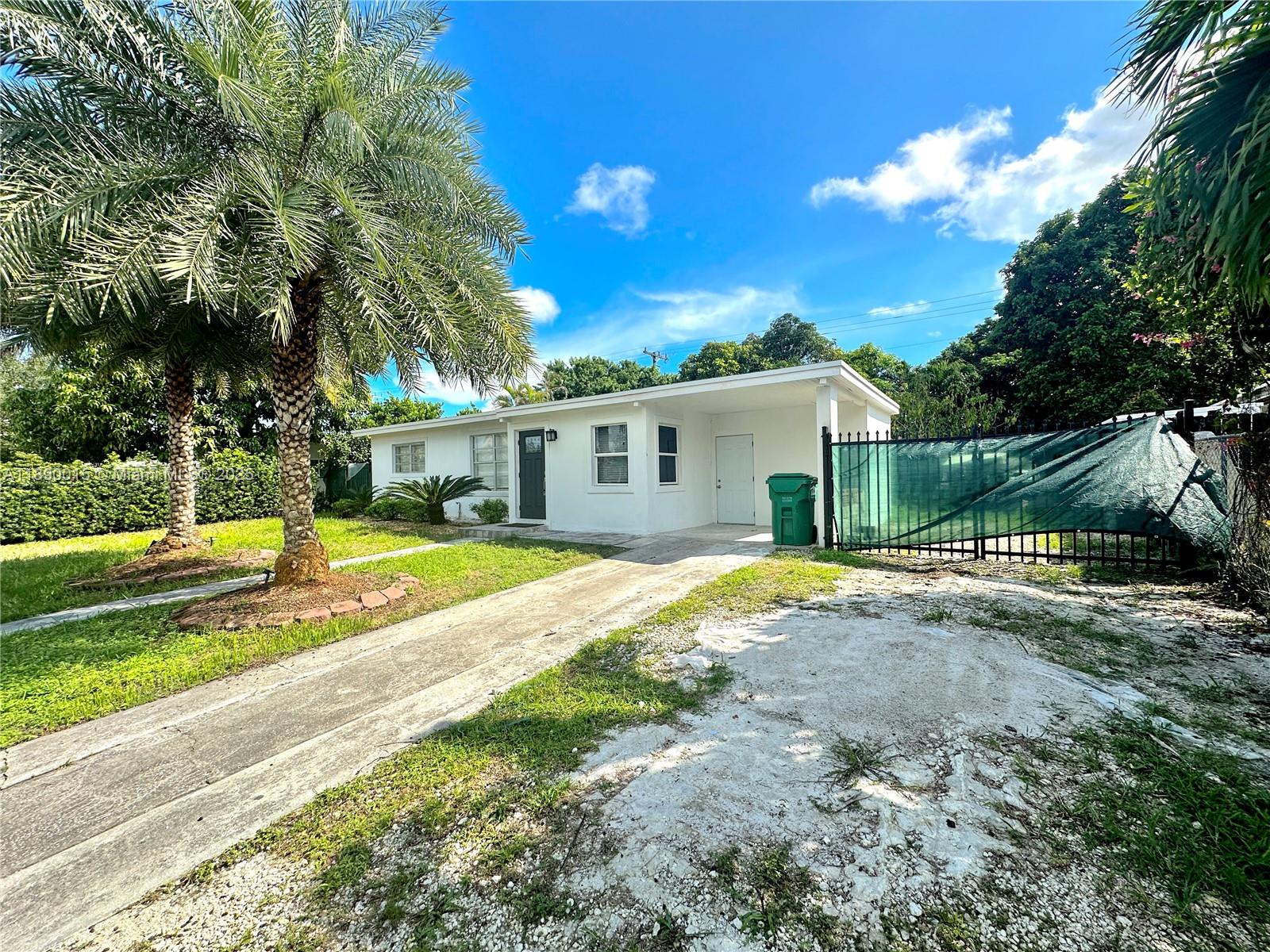 11820 Southwest 188th Street Miami, FL 33177 - Photo 1 of 9 a view of a house with backyard and a tree