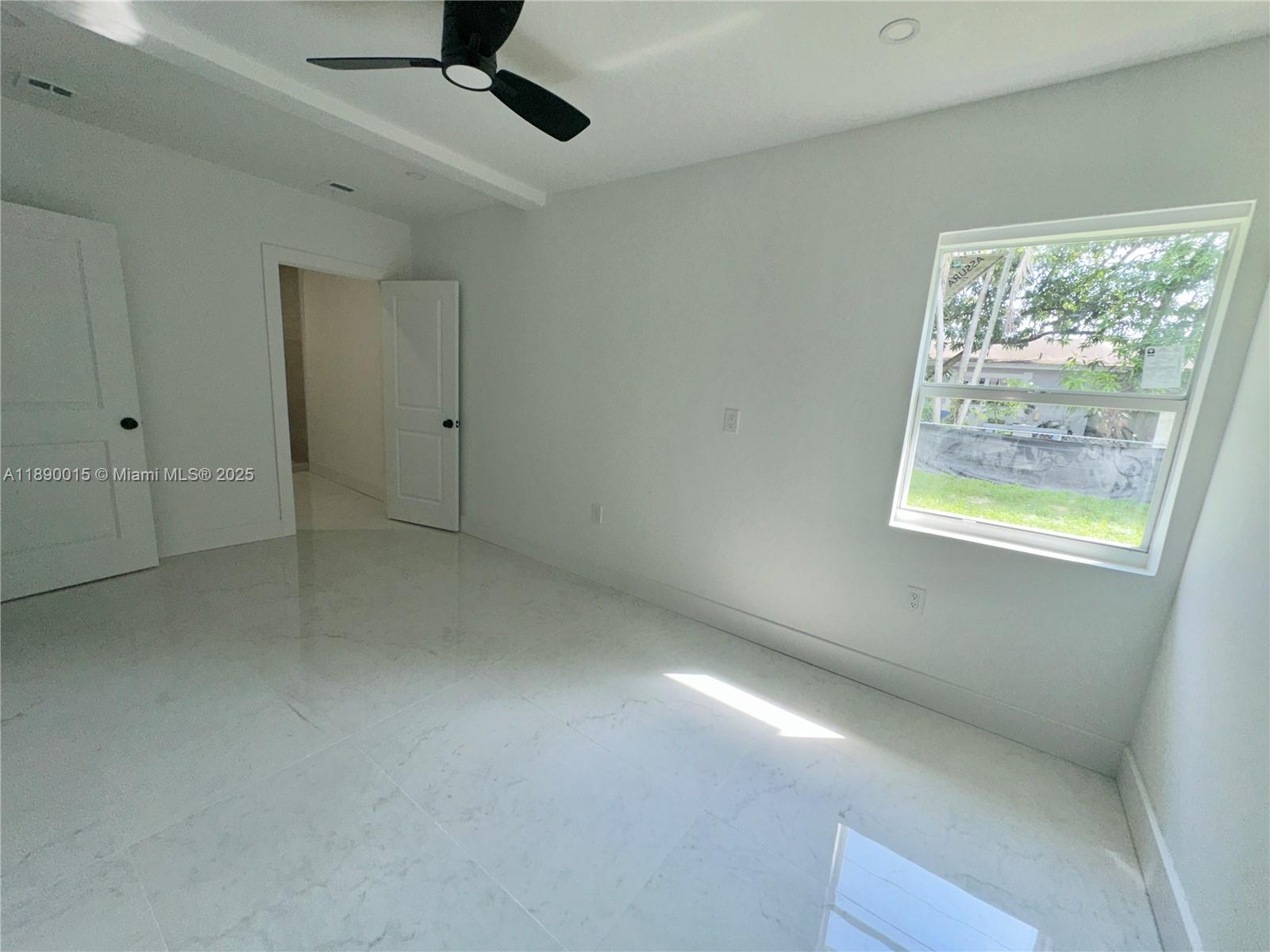 11820 Southwest 188th Street Miami, FL 33177 - Photo 4 of 9 a view of an empty room with a window