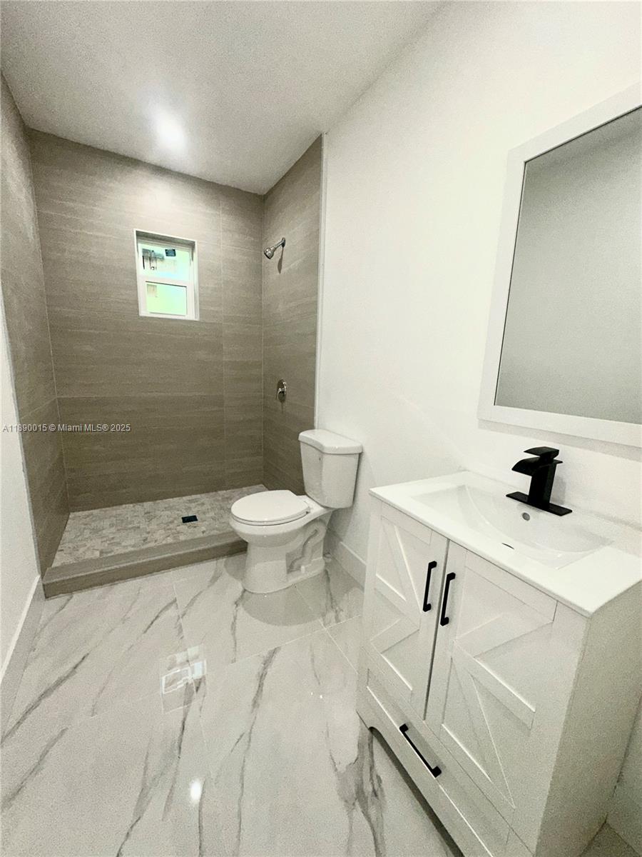 11820 Southwest 188th Street Miami, FL 33177 - Photo 5 of 9 a bathroom with a sink mirror toilet and shower