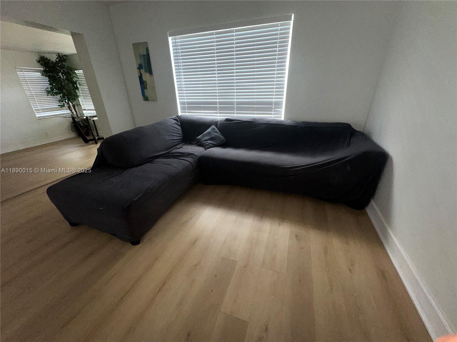 11820 Southwest 188th Street Miami, FL 33177 - Photo 7 of 9 a living room with furniture and a window