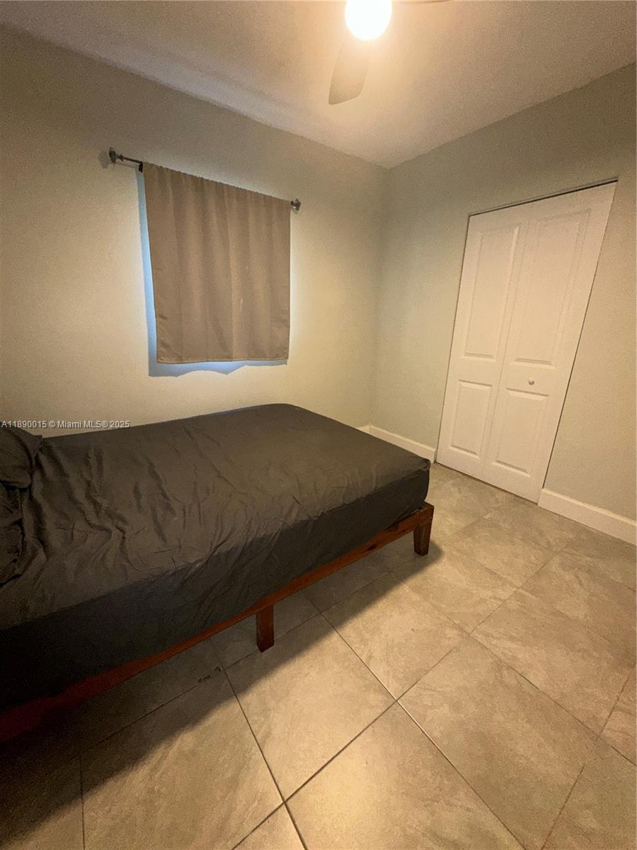 11820 Southwest 188th Street Miami, FL 33177 - Photo 8 of 9 a bedroom with a bed and a cabinets