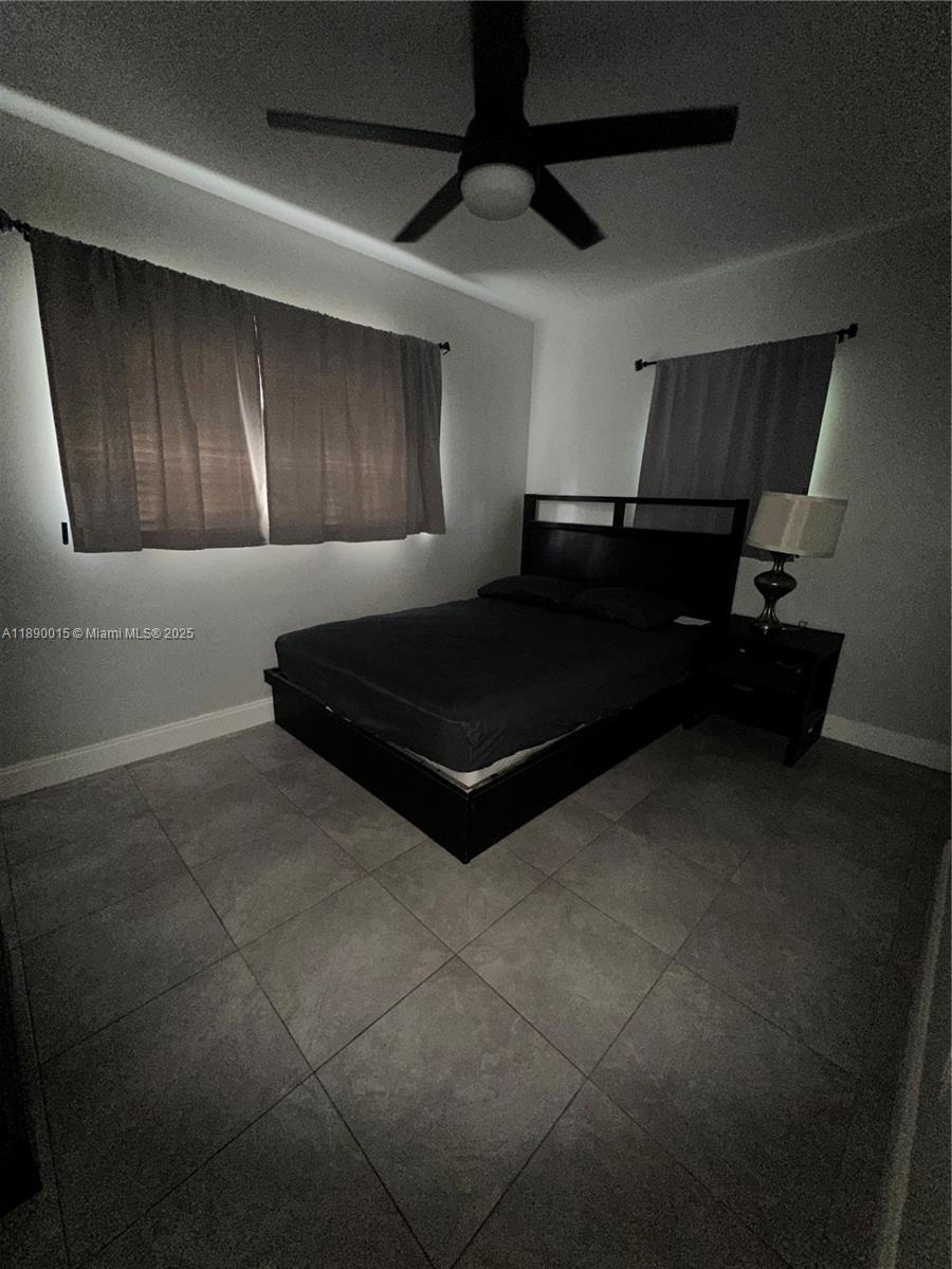 11820 Southwest 188th Street Miami, FL 33177 - Photo 9 of 9 a room with a couch and a ceiling fan