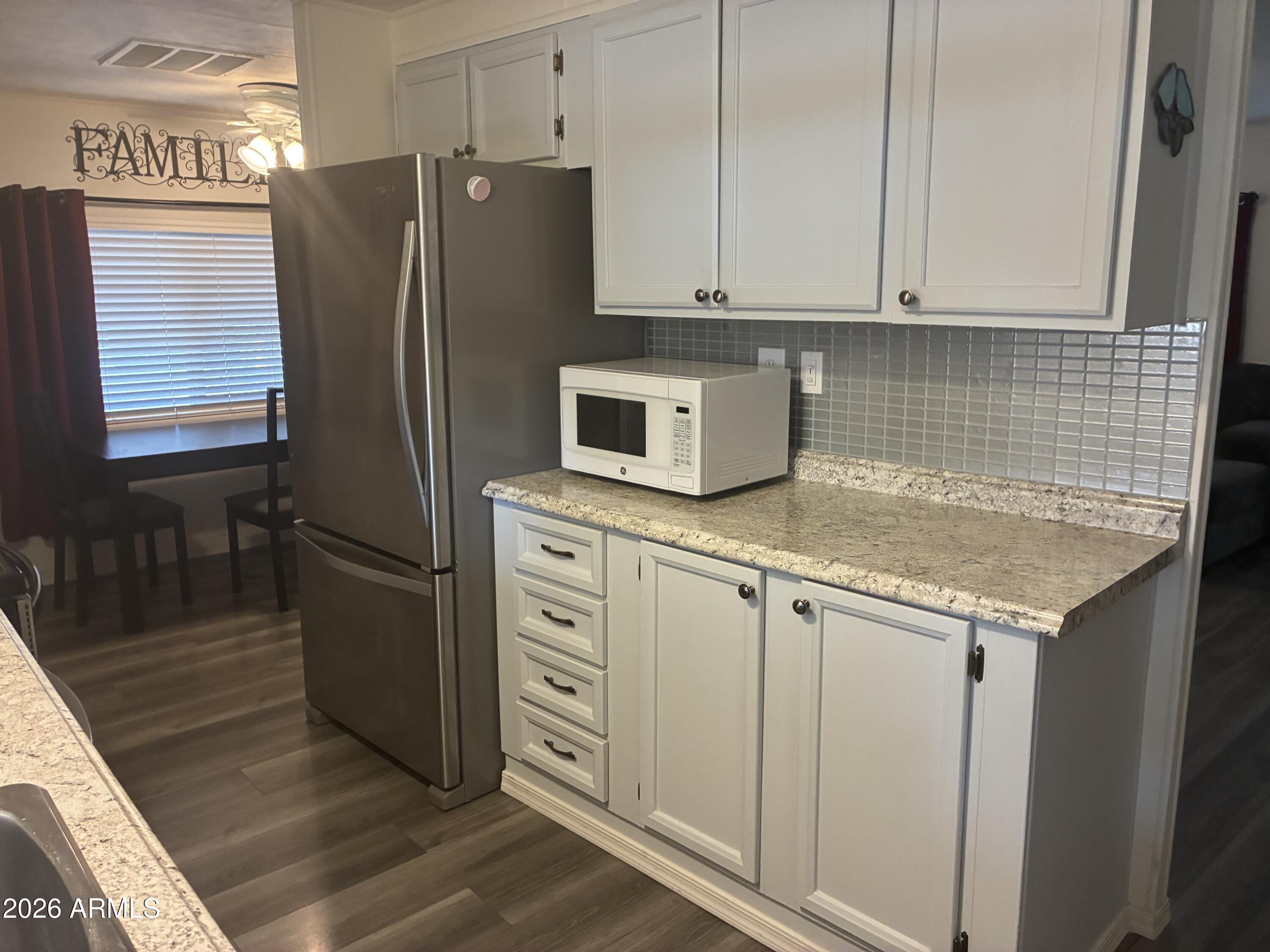 53 North Mountain Road, Unit 58 Apache Junction, AZ 85120 - Photo 10 of 39 a kitchen with stainless steel appliances granite countertop a refrigerator a stove and a sink