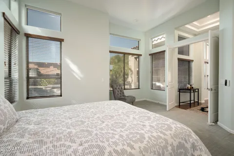 a bedroom with a large bed and a window