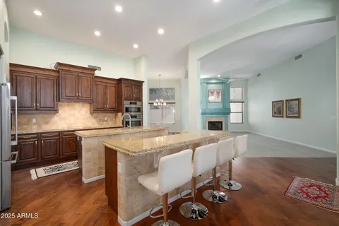 a large kitchen with a table and chairs in it
