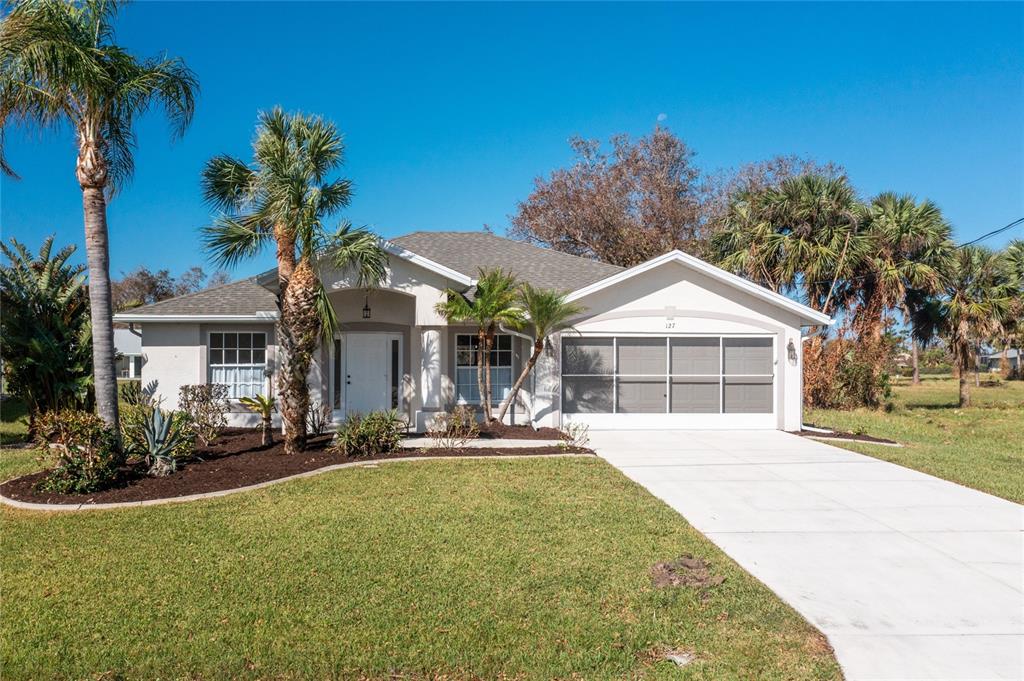 127 Marker Road Rotonda West, FL 33947 - Photo 1 of 1 a front view of house with yard and green space