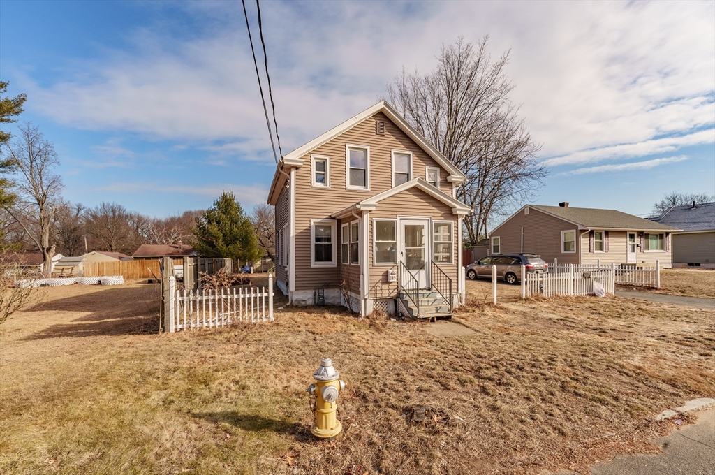 a front view of a house with a yard covered with snow