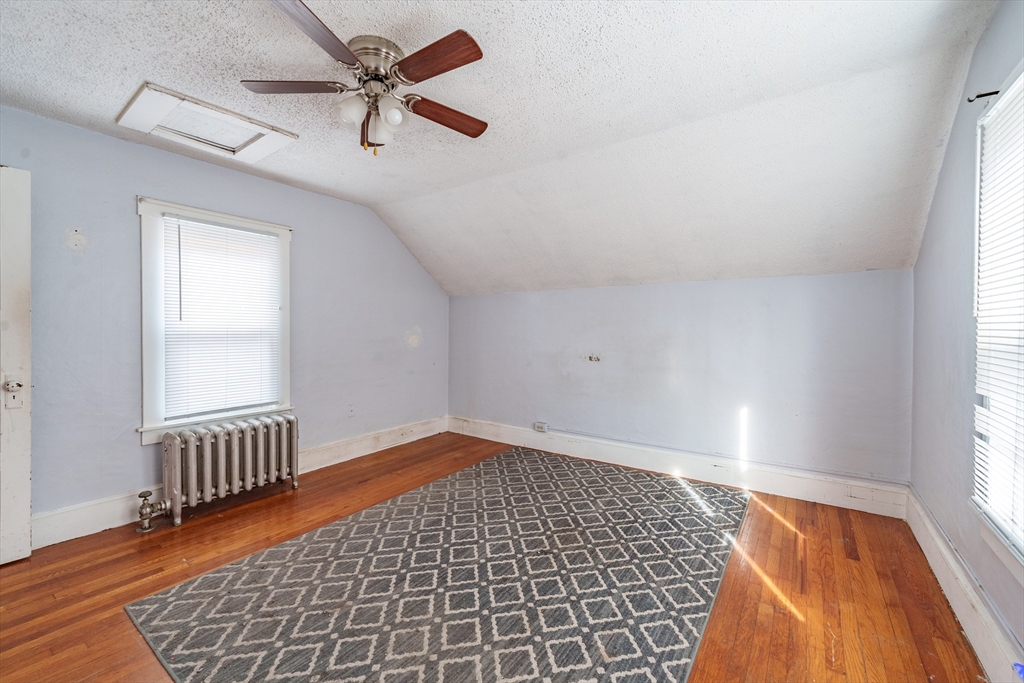245 Arthur Street Springfield, MA 01104 - Photo 12 of 20 an empty room with wooden floor fan and windows